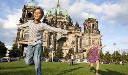 Boy and girl playing in front of Berliner Dom