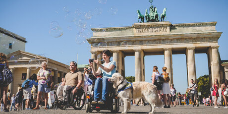 Barrierefrei: Frau im Rollstuhl vor dem Brandenburger Tor