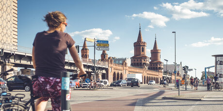 a cyclist in front of the Oberbaumbrücke in Berlin