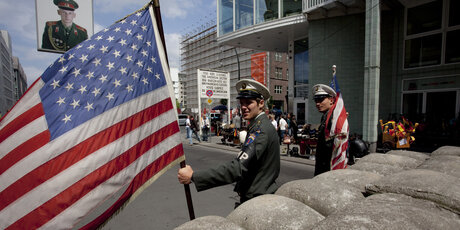"Soldiers" with a flag at Checkpoint Charlie