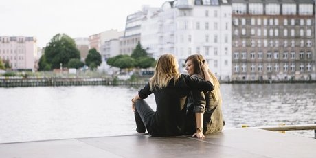 rear view of loving women couple in Berlin, embracing