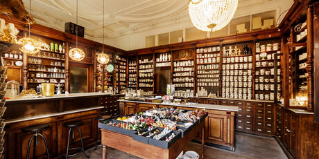 Interior Kühn Ceramics Shop wooden shelves with crockery and cups