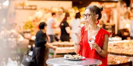 Spanish woman eating jamon at the market