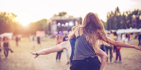 Visitors celebrate at an open air festival