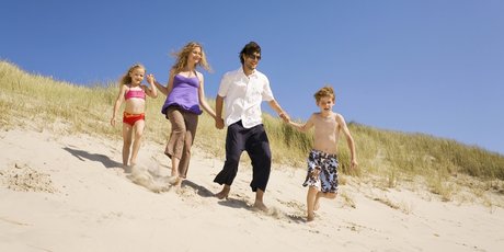 Germany, Baltic sea, Family running down sand dunes