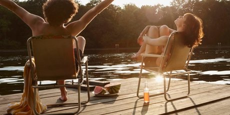 Germany, Berlin, Young couple relaxing on chairs