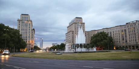 Strausberger Platz in Berlin with fountain at dusk