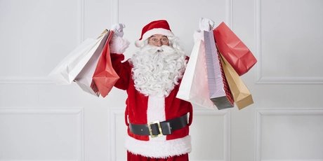 Portrait of Santa claus holding shopping bags