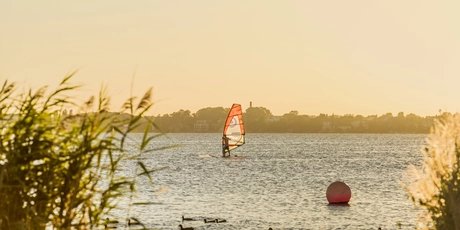 A surfer on the Großer Müggelsee in Berlin, a popular destination