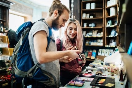 Two Young Backpackers Exploring A Store Together