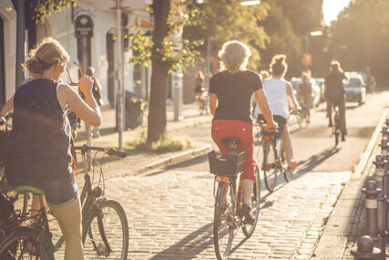 Group of cyclists cycling through Berlin in summer