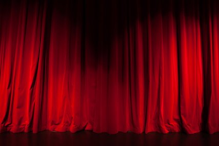 Curtain from the theatre with a spotlight as background