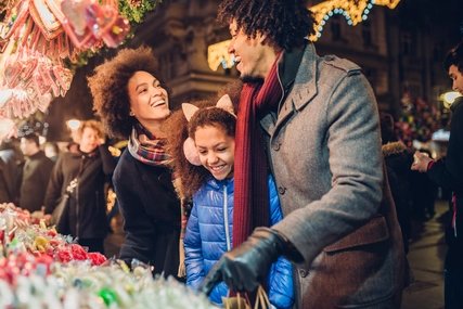 Laughing young family shopping for candy and Christmas presents