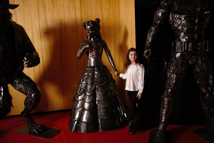 Girl with exhibit at the Gallery of Steel Figures Berlin