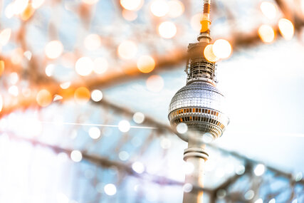 Berlin Tv-tower behind golden shining Christmas lights