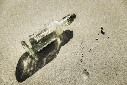 Overhead view of message in bottle on beach, Cape Town, South Africa