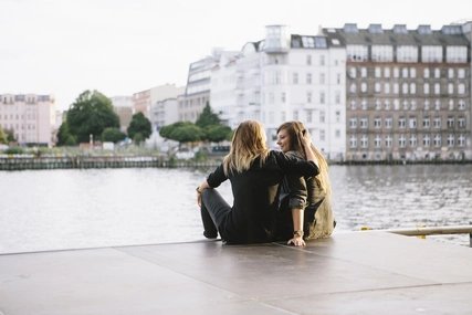 rear view of loving women couple in Berlin, embracing