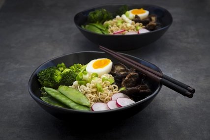 Ramen soup Ramen soup with egg, sugar peas, broccoli, noodles, shitake mushroom and red radish in a black bowl