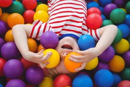 Cute smiling boy in sponge ball pool