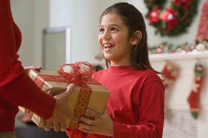Hispanic girl receiving Christmas gift