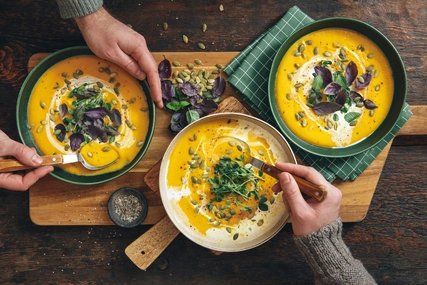 Männer, die vegane Kürbiscremesuppe essen