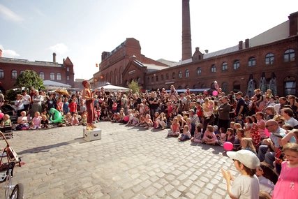 Summer festival at the courtyard of the Kulturbrauere A clown juggles at the summer festival at the Kulturbrauerei in Berlin Prenzlauer Berg