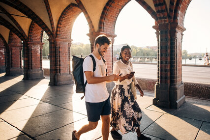 Couple walking across the Oberbaumbrücke in Berlin