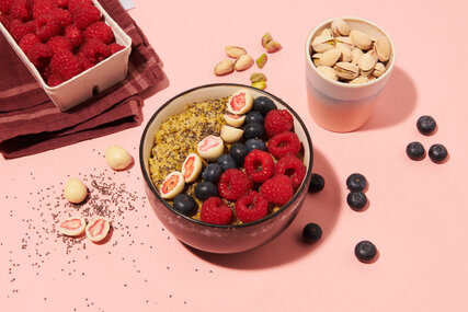Rice pudding bowl with raspberries, pistachios and blueberries 