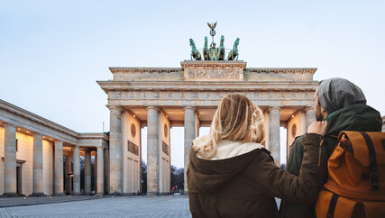 Young couple sightseeing at Brandenburg Gate in winter 