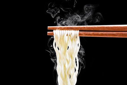 Delicious ramen noodles Noodles with chopsticks against a black background