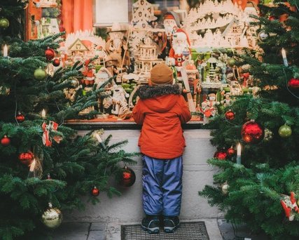 Little boy standing near Christmas tree in Rothenburg