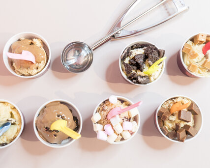 Cookie dough for spooning with toppings and sauces at Spooning Cookie Dough