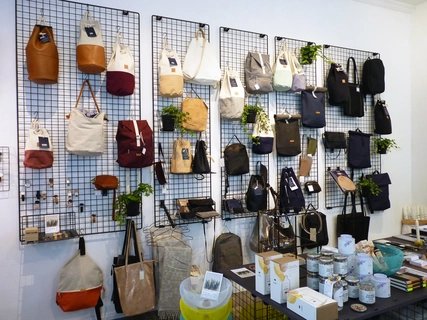 Shopping in Berlin Second hand and vintage shop with bags on a grid on the wall