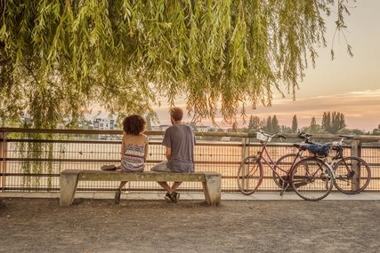 Lake Rummelsburg promenade Romantic break of two cyclists at Lake Rummelsburg in Berlin
