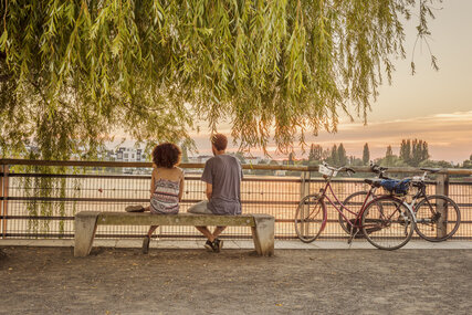 Romantic break of two cyclists at Lake Rummelsburg in Berlin