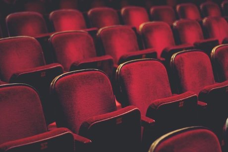 Empty comfortable red seats with numbers in cinema
