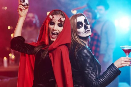 Women in creepy costumes dancing at Halloween party