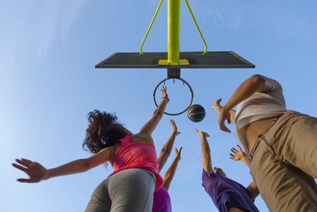Group of Friends Jumping for a  Basketball