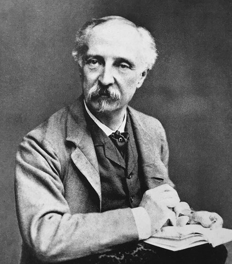 Edward W. Godwin mit Skizzenbuch in der Hand um 1880