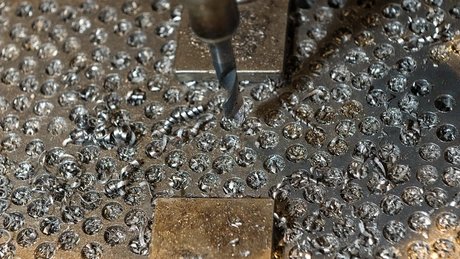 Die Bohrmaschine in der Historischen Werkstatt wird von einer Dampfmaschine über Lederriemen und eine Transmissionswelle angetrieben.