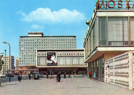 Postkarte von 1964 mit dem Karl-Marx-Allee-Ensemble Berlin, erbaut von Josef Kaiser. Abb.: Kino „International” mit Heinz Aust (1961–63), Hotel „Berolina” mit Günter Kunert (1961–64, 1995 abgerissen), Restaurant „Moskau” mit Horst Bauer