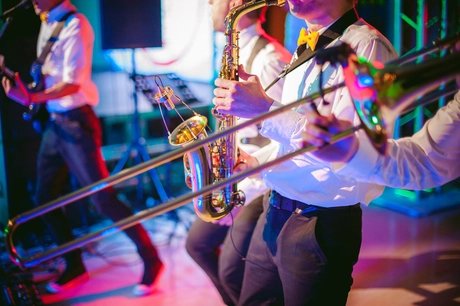 Midsection Of Men Playing Trumpet