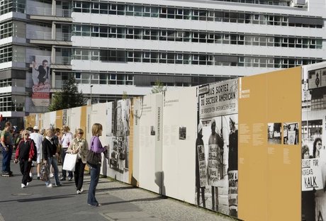 Tourists in front of a wall memorial