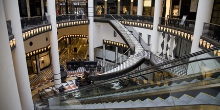 Atrium of a mall with multiple stairs and escalators