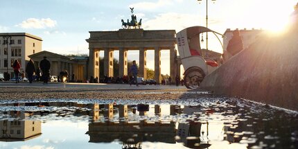 Brandenburg gate in Berlin: Reflection of the Brandenburg Gate in a puddle