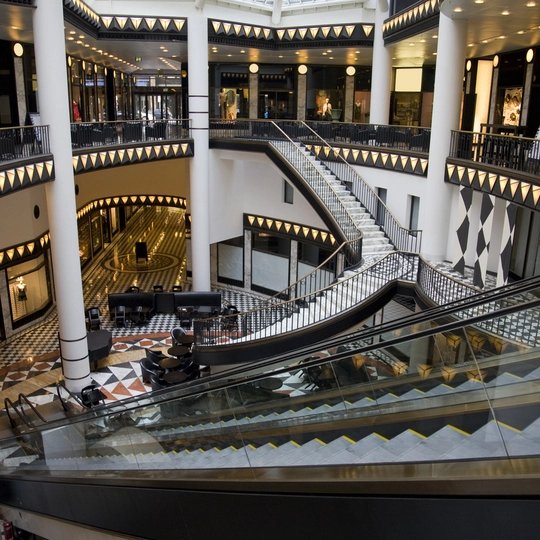 Atrium of a mall with multiple stairs and escalators