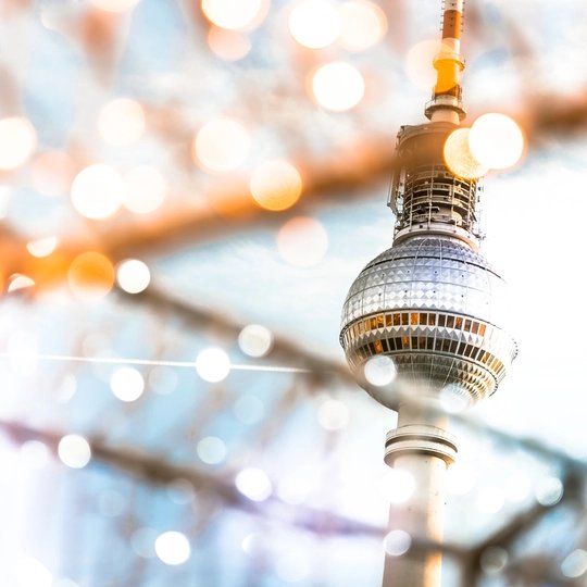 Berlin Tv-tower behind golden shining Christmas lights