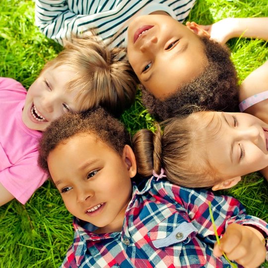 High angle view of children lying in a park