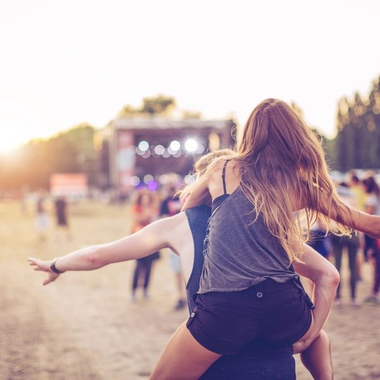 Visitors celebrate at an open air festival