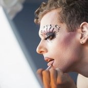 Young man applying drag makeup